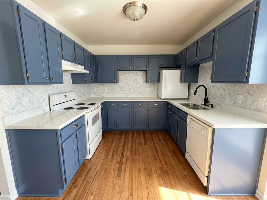 Builder-grade kitchen upgraded with quartz counters and a tile backsplash — after