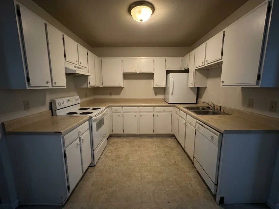 Builder-grade kitchen upgraded with quartz counters and a tile backsplash — before