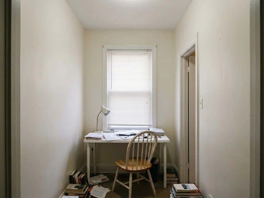 Small study upgraded with wall shelving, a corkboard, and a softer color scheme. before AI redesign